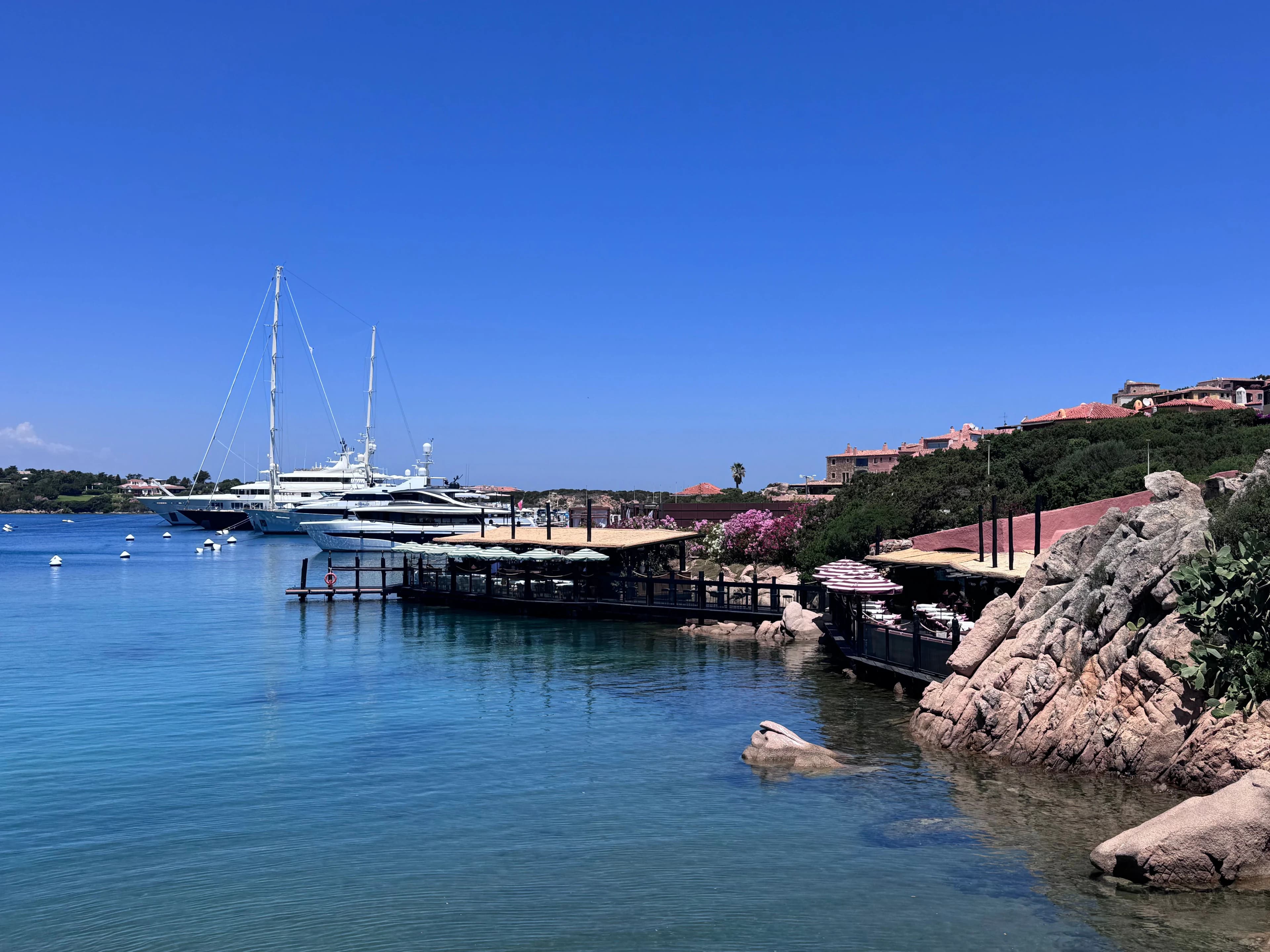 The marina at Porto Cervo on the Costa Smeralda, with boats moored and houses overlooking the harbour